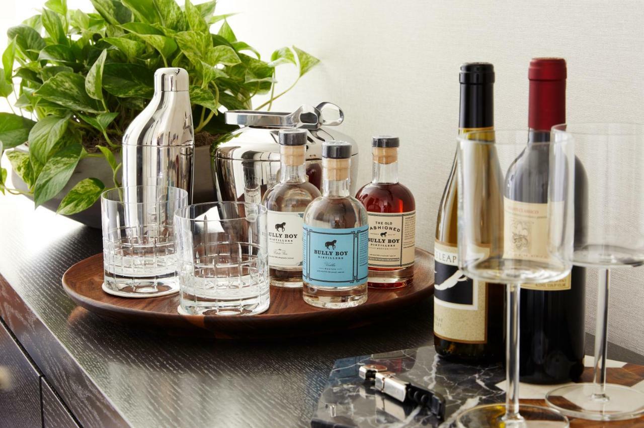 The Whitney Hotel Boston Extérieur photo A bar cart with a selection of liquor and wine